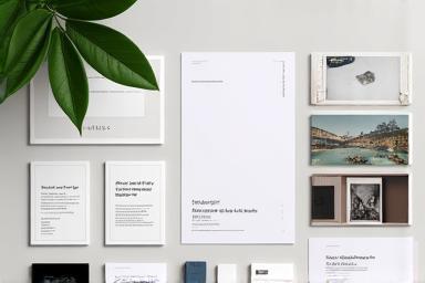 Collection of documents, photos, and USB drive on a desk